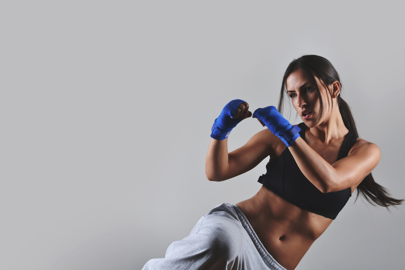 fitness woman with the blue boxing bandages, studio shot